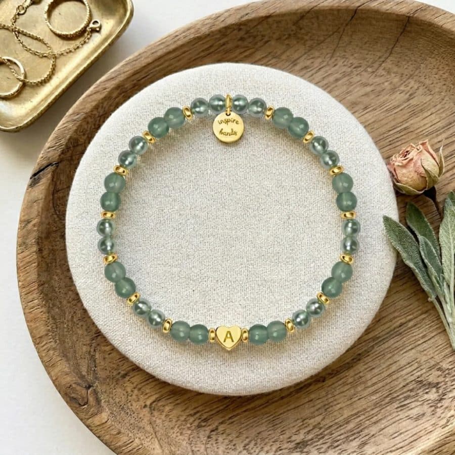 Jade bead bracelet on a wooden plate
